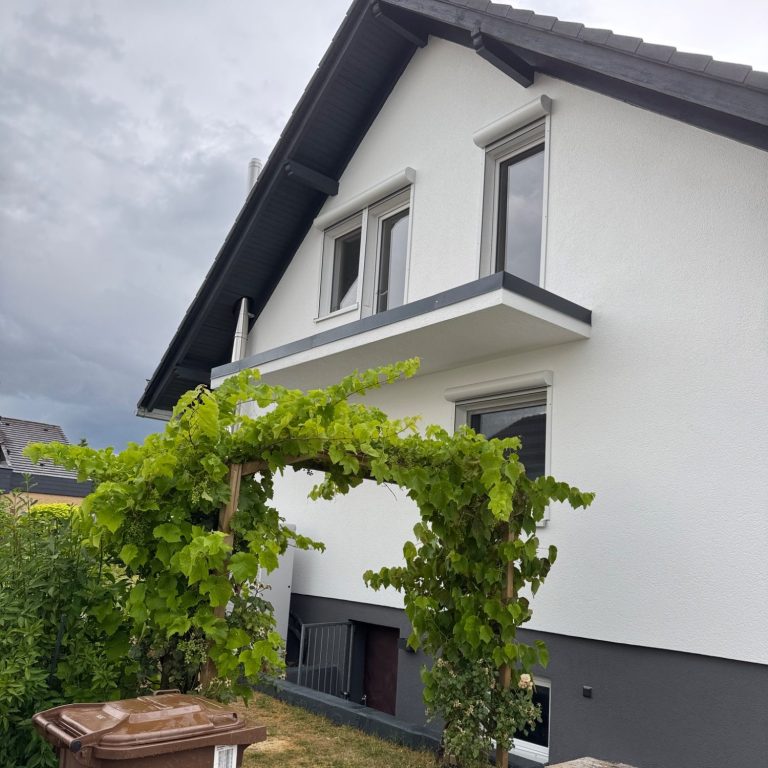 Fassadensanierung in Kassel mit neuem Putz, Anstrich, Sockel und Gerüst – e & e Bau